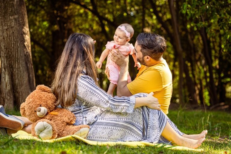Family in a park with their baby on a sunny day