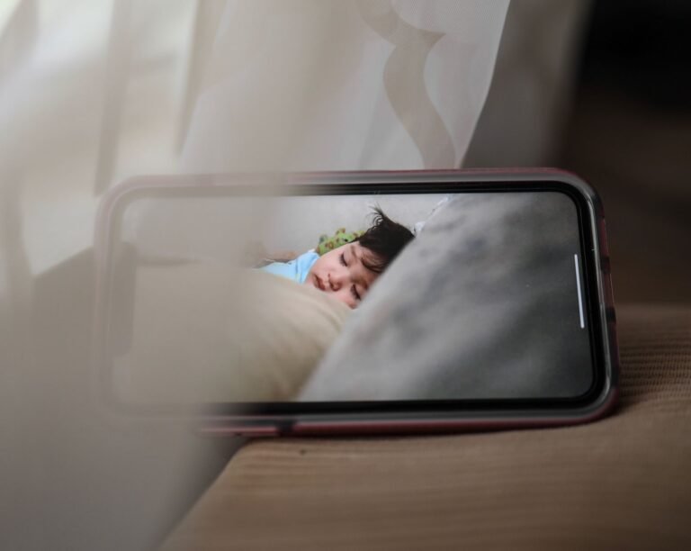 Best baby monitors Canada 2026 — parent reviewing baby monitor feed on smartphone
