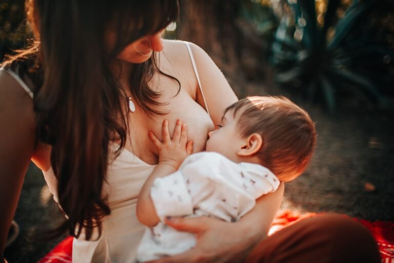 Mother breastfeeding her baby in natural light — Haakaa vs Medela Harmony manual breast pump comparison