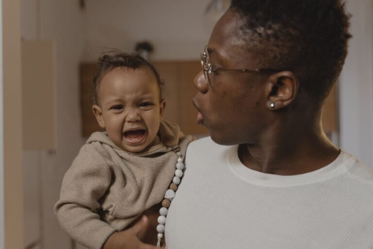 Parent soothing a crying newborn at home — best newborn comfort picks 2026, photo by Tima Miroshnichenko on Pexels