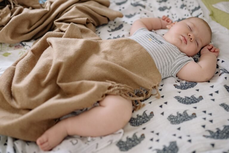 Sleeping baby wrapped in a swaddle — Love To Dream Swaddle UP vs HALO Sleepsack comparison