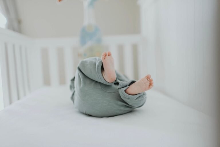 Baby asleep in a nursery crib — best nursery sleep setup picks 2026, photo by Leah Newhouse on Pexels