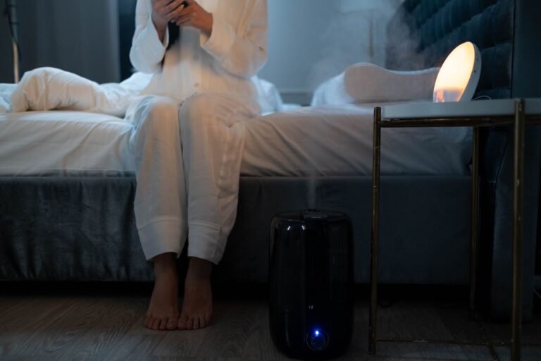 Cool mist humidifier running in a softly lit bedroom at night