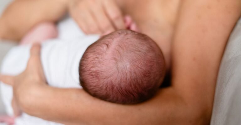 Mother breastfeeding her newborn, used for the Lansinoh vs Haakaa milk collector comparison