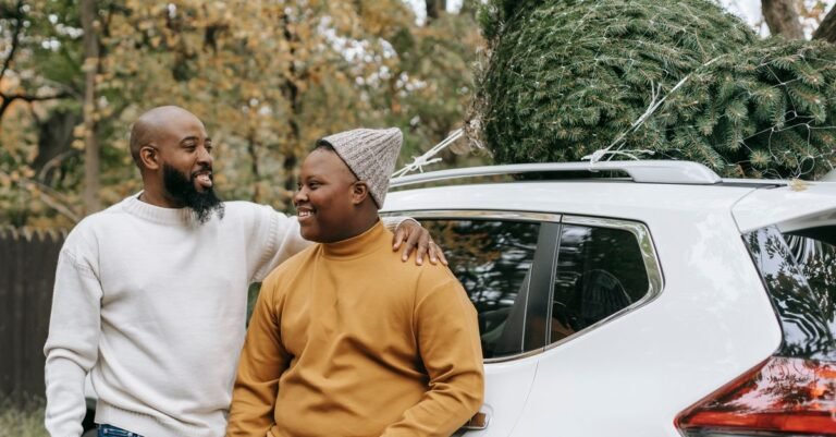 A parent and child standing beside a family SUV